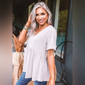 Boutique Babydoll Cream Splice Cross back top. Size Small
